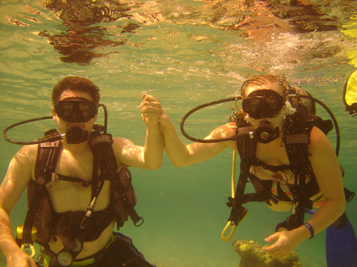 Divers Holding Hands Under Water